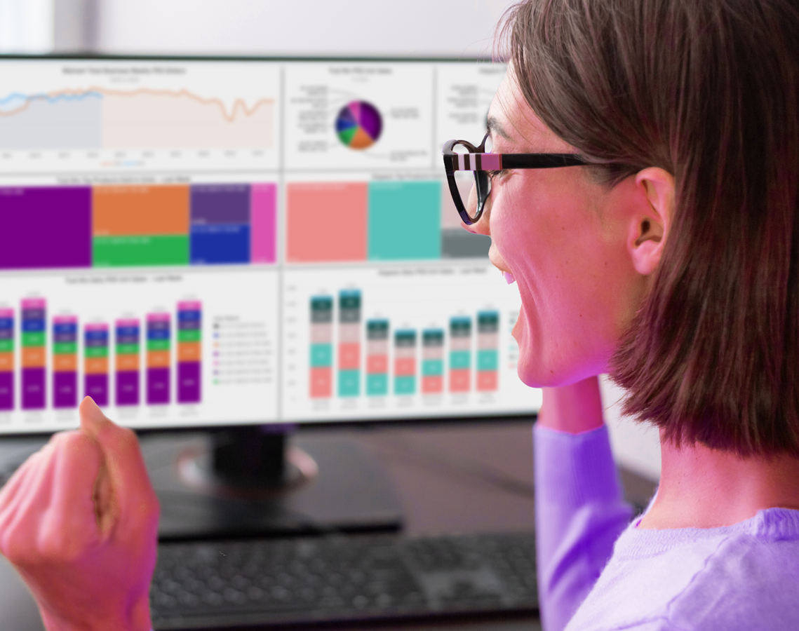Woman analyzing colorful charts and graphs on a computer screen.